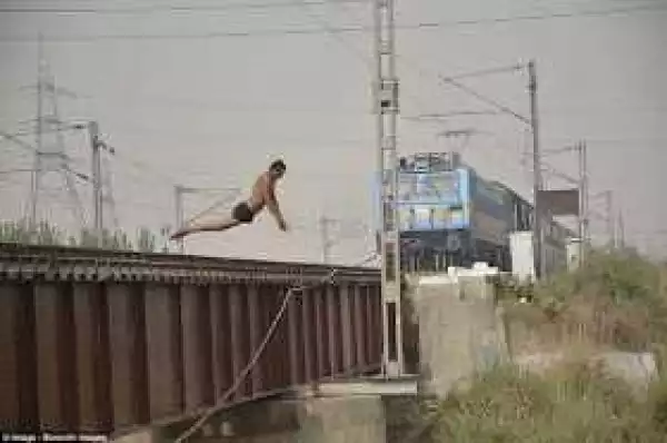 Photos; See How These Youngsters Are Risking Their Lives By Diving From Rail Bridge Into A Canal